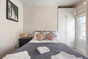 a bedroom with a bed with two towels on it at 1 Bed Executive Apartment near Liverpool Street Station FREE WIFI by City Stay Aparts London in London