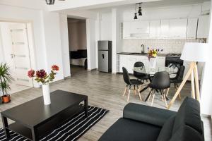 a living room and kitchen with a couch and a table at Diamond View Apartments in Mamaia