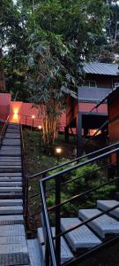 a set of stairs leading up to a building with lights at Santhi Hill View Resort in Munnar