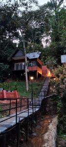 a house with a bunch of benches in front of it at Santhi Hill View Resort in Munnar