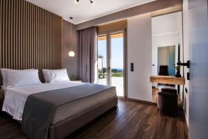 Postel nebo postele na pokoji v ubytování Villas Mandalos