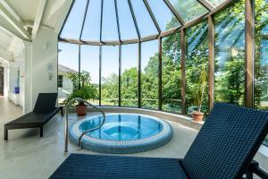 a hot tub in a conservatory with a glass ceiling at The Mole Resort - Hotel rooms in Umberleigh Bridge