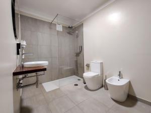 a bathroom with a toilet and a sink at Salty Swell in Porto