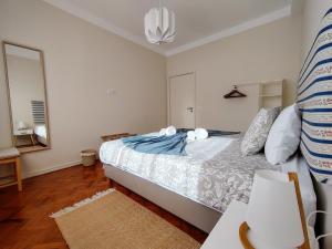 a bedroom with a bed and a mirror at Salty Swell in Porto