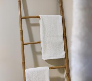 a towel ladder with two white towels on it at Salty Swell in Porto