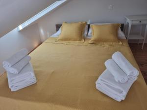 a bedroom with a bed with towels on it at Penthouse in old Dalmatian house - Flybridge in Hvar