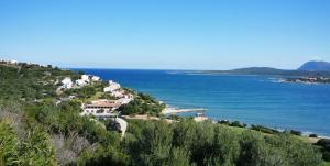 a village on a hill next to the ocean at Hotel Palumbalza Porto Rotondo in Porto Rotondo