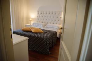 a bedroom with a bed with a white headboard at B&B L'ORIZZONTE in Crotone