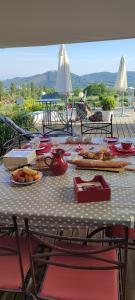 einen Tisch mit Stühlen und Essen oben in der Unterkunft Domaine Le Lanis Chambre d'hôtes piscine spa in Saint-Girons