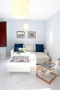 a living room with a white couch and a coffee table at Sleepin Sevilla in Seville