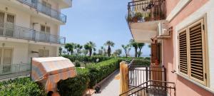 a person holding an umbrella on a balcony of a building at Casa Marco in Praia a Mare
