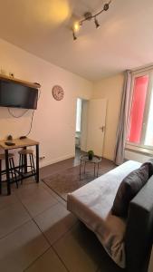 a bedroom with a bed and a flat screen tv at Logesty Home proche Paris et Metro in Pantin