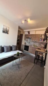 a living room with a couch and a table at Logesty Home proche Paris et Metro in Pantin +13 photos