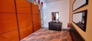 a bedroom with a bed and a dresser and a mirror at Casa Marco in Praia a Mare