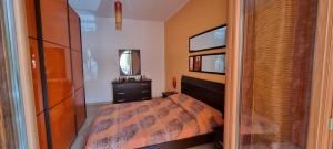 a bedroom with a bed and a dresser and a mirror at Casa Marco in Praia a Mare