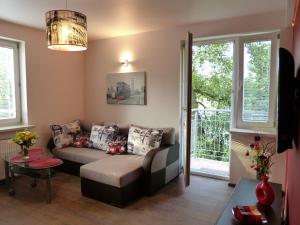 a living room with a couch and a table at Maple Leaf Apartment in Krakow