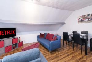 a living room with a blue couch and a table at DD Apartment 9 - Free Parking - Fast WiFi in Castle Donington