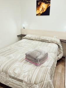 a bed with a blanket on it in a bedroom at STUDIO LOFT SKI 53 CONFORT in Pas de la Casa