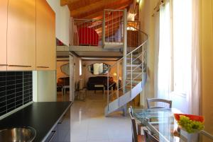 a kitchen with a spiral staircase and a dining room at GetTheKey Boldrini Lofts in Bologna
