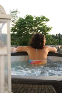 a woman sitting in a bath tub at EnjoyTrulli - Countryside in Noci