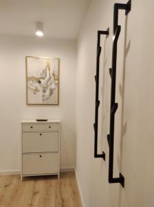 een kamer met een dressoir en een schilderij aan de muur bij ENDURO apartament przy Szyndzielni i Dębowcu in Bielsko-Biala