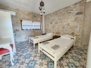 a bedroom with two beds and a piano at Eco Farm Boutique Hotel in Turgutreis