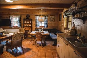 a kitchen with a table and chairs in a cabin at Chalupa u Dubu in Loučná nad Desnou