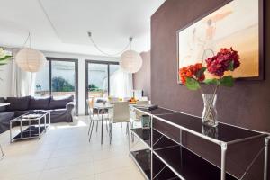 a living room with a table with flowers in a vase at Inside Barcelona Apartments Sants in Barcelona