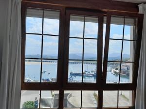 a view of a harbor from a window at La Casa de la Bahía in San Vicente de la Barquera