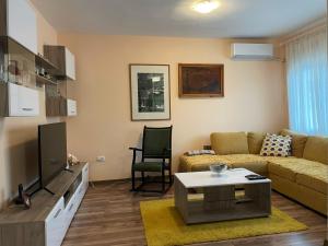 a living room with a couch and a table at Apartment Vrbisao in Cetinje