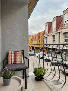 a balcony with a chair and a street at Apartment Vrbisao in Cetinje