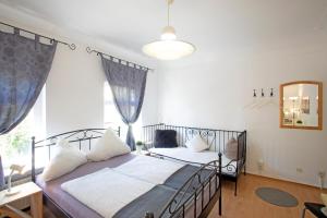 a bedroom with a bed and a large window at Hostel Westküste in Lindau