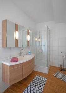 a bathroom with a sink and a shower at Hostel Westküste in Lindau