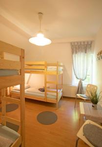 a room with two bunk beds and a table at Hostel Westküste in Lindau