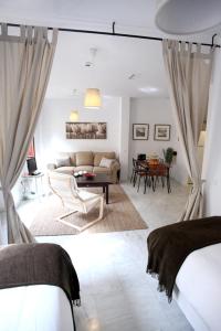 a living room with a couch and a table at Sleepin Sevilla in Seville
