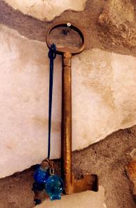 a rusty pipe with blue glass beads attached to it at Pasas Castle - Unique Luxury Apartments in Naxos Chora