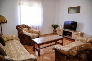 a living room with two chairs and a coffee table at Apartment Nikola in Kotor