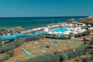 a resort with a water park with slides and umbrellas at Mitsis Cretan Village in Hersonissos