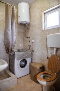 a bathroom with a washing machine and a toilet at Apartment Nikola in Kotor +17 photos