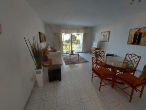 a living room with a table and chairs at Miraflores Resort in La Cala de Mijas