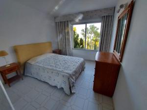 a small bedroom with a bed and a window at Miraflores Resort in La Cala de Mijas