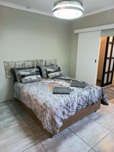 a bedroom with a large bed in a room at Lazy Days Apartments - Jeffreys Bay in Jeffreys Bay