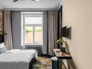a hotel room with a bed and a window at Numa Prague Root in Prague