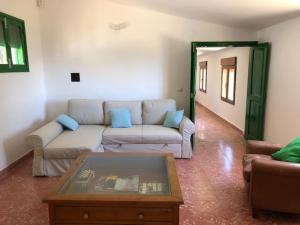 a living room with a couch and a coffee table at Casa-Finca El Maipéz de Tejeda in Las Palmas de Gran Canaria