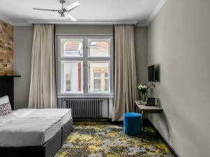 a bedroom with a bed and a window at Numa Prague Root in Prague