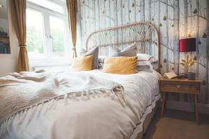 a bedroom with a large white bed with a window at Waves - Duplex Apartment Stoke Fleming in Stoke Fleming