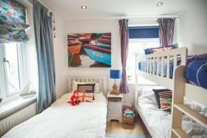 a bedroom with two beds and a bunk bed at Waves - Duplex Apartment Stoke Fleming in Stoke Fleming