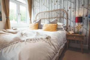 a bedroom with a white bed with a window at Waves - Duplex Apartment Stoke Fleming in Stoke Fleming
