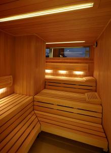 a sauna with two benches in a wooden room at AMERON Hamburg Hotel Speicherstadt in Hamburg