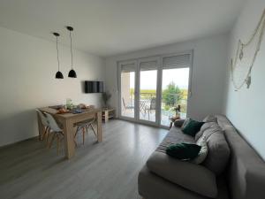 a living room with a couch and a table at Apartment Amazing Island in Povljana